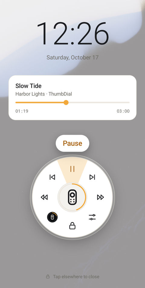 Lock screen with the ThumbDial dial open over the now-playing card, Play/pause highlighted and labelled Pause.